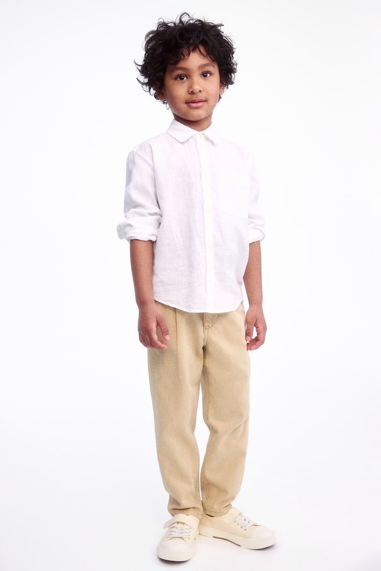H&M Loose-fit tapered twill chinos Fabrikpreis