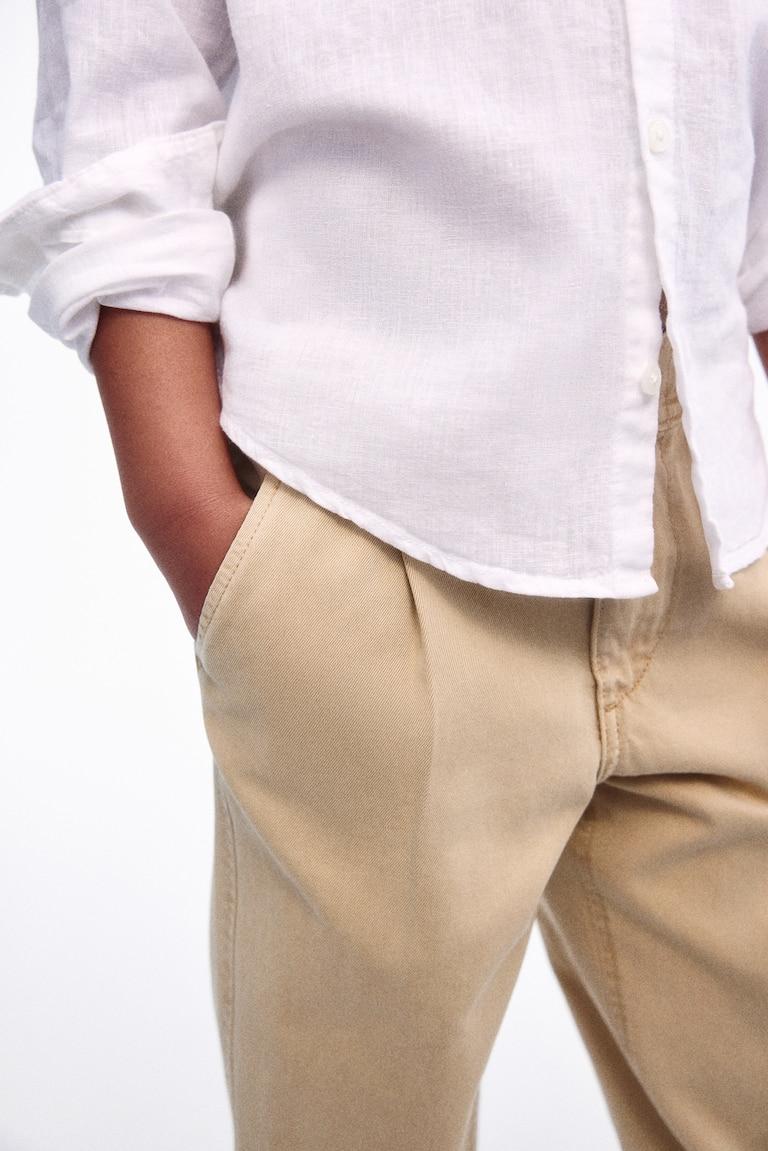 H&M Loose-fit tapered twill chinos Fabrikpreis